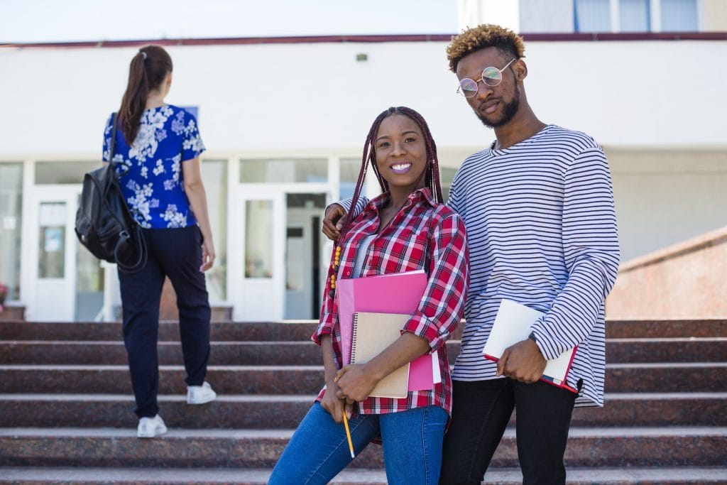 delighted-black-students-posing-stairs